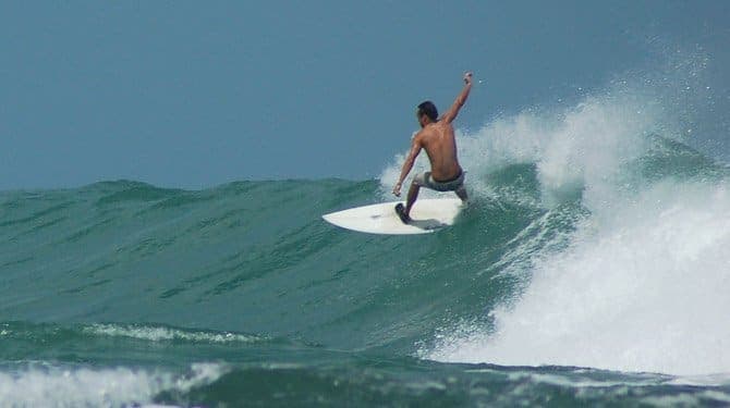 Surfer carving a clean wall on the southern Caribbean coast