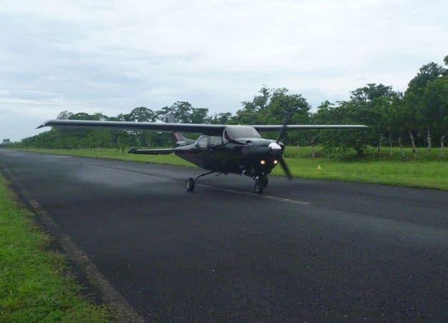 Light aircraft on the airstrip — SANSA's scheduled hops and private charters connect San José to the Caribbean coast in around 40 minutes